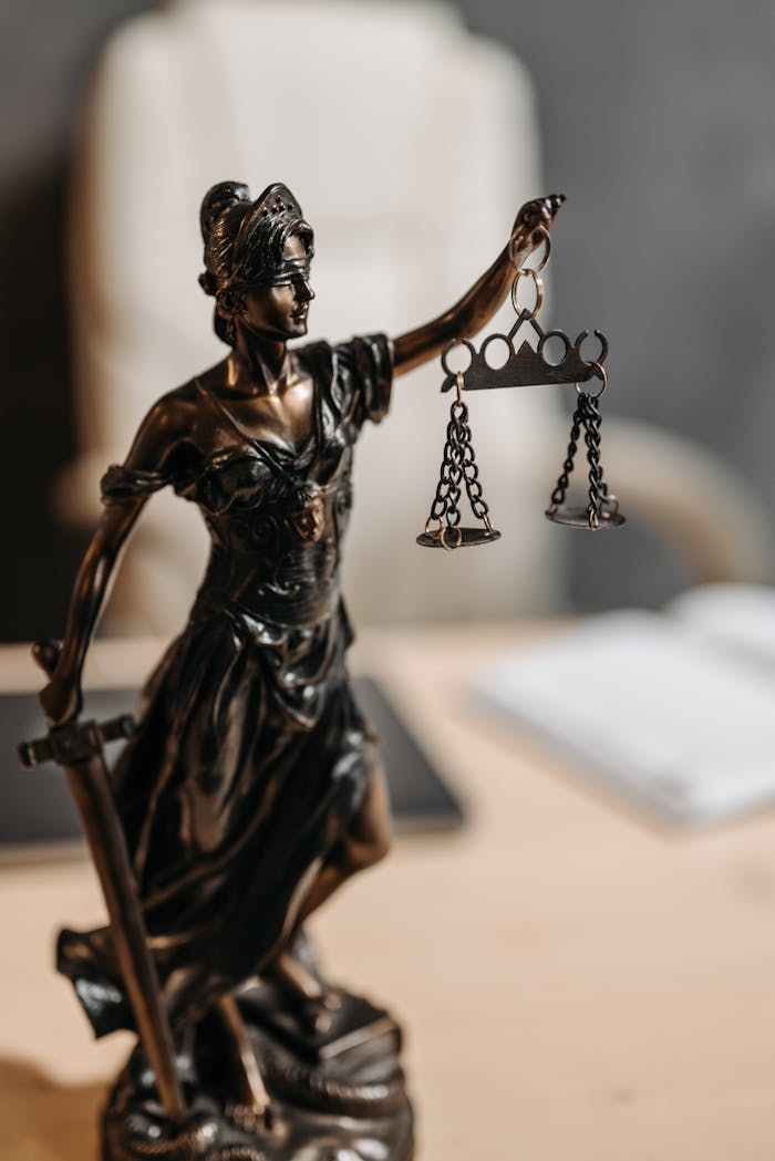 Sobre Bronze Lady Justice statue with scales and sword, symbolizing fairness and law.